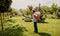 Gardener in protective mask and glasses spraying toxic pesticides trees