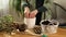 Gardener putting fibre soil by hands, transplant plant Crassula into new pot at home