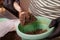 Gardener putting soil into flower pot for planting indoor flowers. Close up.