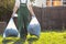 The gardener removes the bags of leaves. Light. Green uniform