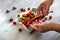 Gardener& x27;s hands preparing tomatoes. Cherry tomatoes on light background.