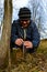 A gardener`s woman clogs a cut-off part of the grafted tree to prevent rotting at this place in close-up.