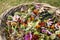 Gardener`s woven basket full of faded flower heads with retro scissors