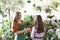 Gardener selling plant to woman