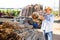 Gardener stacking bundles of bamboo poles on backyard