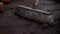 Gardener sweeping wooden hut floor covered in soil and dirt