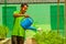 Gardener in the uniform watering plants