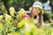 Gardener in uniform working in roses plant