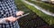 Gardener using digital tablet at greenhouse