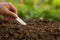 Gardener using garden trowel taking a good soil at vegetable