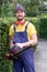 Gardener using an hedge clipper in the garden