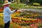 A gardener waters the flowers.