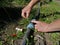 The gardener winds the thread to install the tap on the irrigation system