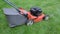 Gardener worker shorts rubber boots start grass lawn mower push