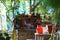 Gardener workplace in greenery. Tools and pots for plants cultivating on wooden table in greenhouse