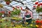 Gardener works in a greenhouse in a flower shop