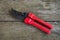 Gardeners hand tool - red pruner. Closed pruner