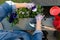 Gardeners hands planting flowers in pot with dirt or soil in container on terrace balcony garden. Gardening concept