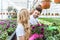 Gardeners wearing protective gloves and planting blooming flowers