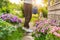 Gardening agriculture concept. Gardener hands holding watering can watering irrigating plant. Unrecognizable woman