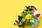 Gardening background with gerbera, tolls and flowers plant in box on yellow background. Top view. Copy space