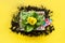 Gardening background with gerbera, tolls and flowers plant in box on yellow. View from above