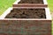 Gardening background, modern vegetable garden with raised briks beds , ready for planting