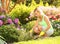 Gardening. Blonde young woman planting flowers in garden