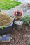 Gardening - composter, bucket with stones and wheelbarrow with soil