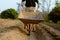 Gardening concept a young male farmer shoving a gardening cart among vegetable plots in his small peaceful garden