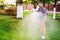 Gardening details - man working with hose and watering the lawn