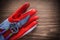 Gardening glove and stainless secateurs on wooden background