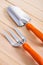 Gardening hand tools - trowel and fork on wooden boards