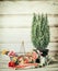 Gardening setting with basket, flowers , watering can, tools and myrte plant on table at wooden background