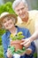 Gardening together brings us closer. Portrait of a happy senior couple gardening together.