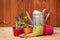 Gardening tools, empty flower pots, purple crocuses and daffodil on wooden table. Selective focus