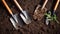 Gardening tools on fertile soil texture background seen from above, top view. Gardening or planting concept. Working in the spring