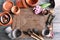 Gardening tools with flowerpots and wicker mat on table