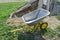 Gardening wheelbarrow for transportation of sand and earth. Two-wheel yellow car