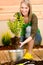 Gardening woman plant spring flower terrace