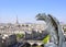 Gargoyle overlooking Paris up on Notre Dame de Paris, France