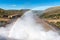 The Gariep Dam overflowing. A rainbow is visible