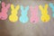 Garland with colorful paper rabbits on gray background. Concept Easter Bunny Banner