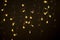 A garland curtain in the form of stars hangs on a dark background.