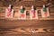 Garland with cute little kraft paper stickers hanging on a rope on wooden clothespins. Xmas. Santa Claus.  Rustic Christmas