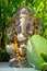 Garland of golden flowers draped around Ganesha