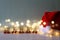 garland lights next to santa hat and wooden letters