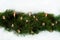 The garland is made of pine branches and decorated with candles, cones and wooden toys on a white background. Christmas, winter, N