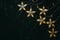 Garland stars yellow light on black stone background. Christmas beautiful background. Top view, flat lay, copy space