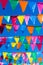 Garlands with colored triangles in blue sky